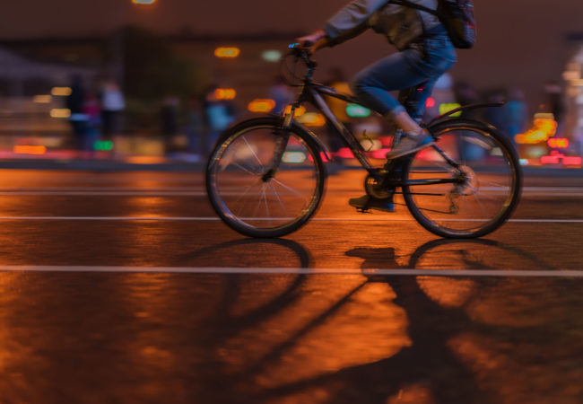 Silhouette of riding Cyclists on the city roadway, night, abstract, motion blur